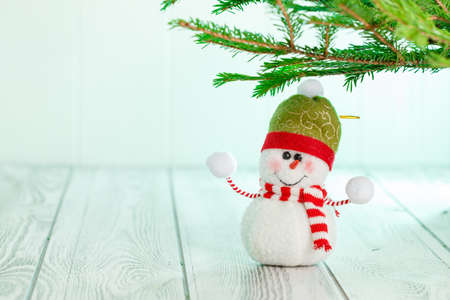 Snowman next to the New Year's tree. Snowman celebrate Christmas. good new year spirit