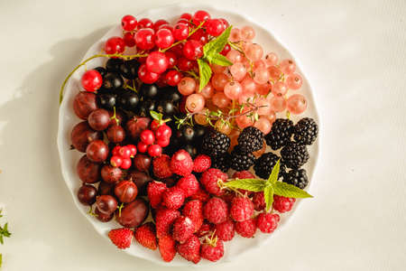Assorted fresh summer berries. Raspberries, gooseberries, blackberries, currants, wild strawberries,...