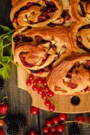 Berry yeast dough pie for tea. Sweet pastries with berry jam. Blackberries, strawberries and currants in dessert. handmade cakeの写真素材