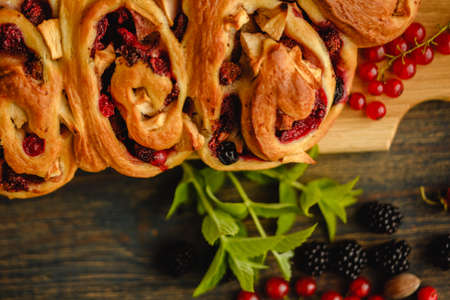Berry yeast dough pie for tea. Sweet pastries with berry jam. Blackberries, strawberries and currants in dessert. handmade cakeの写真素材