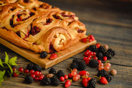Berry yeast dough pie for tea. Sweet pastries with berry jam. Blackberries, strawberries and currants in dessert. handmade cakeの写真素材