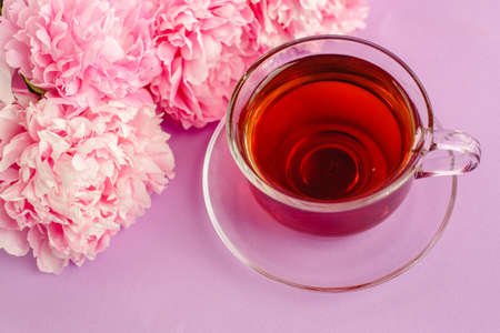 Sweet tea with peonies. Romantic tea party. Drink and flowers.の写真素材