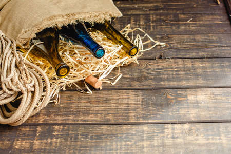 Wine bottle on a wooden background. Winemaking, sommelier.の写真素材