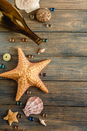 Sea and ocean gifts on a wooden background. marine things. sea products. Water Background for real man captains and sailors. pirate design. Bottle, rope, star. underwater treasures.の写真素材