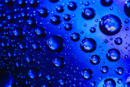 Abstract background about water or space. Multicolored stylish drops. Unusual splashes. It looks like the universe, planets and stars.の写真素材