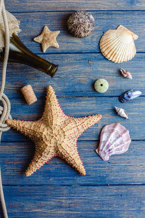 Sea and ocean gifts on a wooden background. marine things. sea products. Water Background for real man captains and sailors. pirate design. Bottle, rope, star. underwater treasures.の写真素材