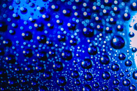 Abstract background about water or space. Multicolored stylish drops. Unusual splashes. It looks like the universe, planets and stars.の写真素材