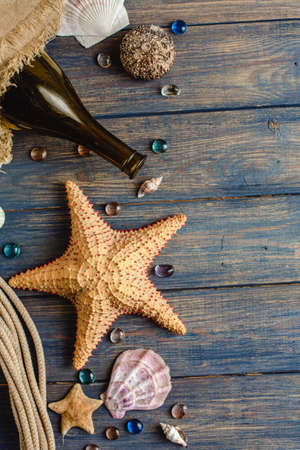 Sea and ocean gifts on a wooden background. marine things. sea products. Water Background for real man captains and sailors. pirate design. Bottle, rope, star. underwater treasures.の写真素材