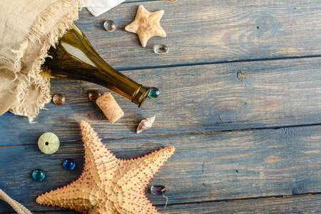 Sea and ocean gifts on a wooden background. marine things. sea products. Water Background for real man captains and sailors. pirate design. Bottle, rope, star. underwater treasures.の写真素材