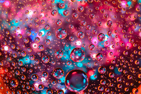 Abstract background about water or space. Multicolored stylish drops. Unusual splashes. It looks like the universe, planets and stars.の写真素材