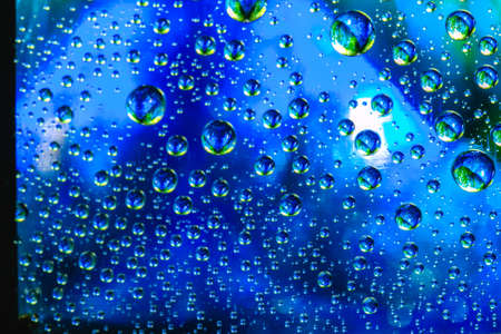 Abstract background about water or space. Multicolored stylish drops. Unusual splashes. It looks like the universe, planets and stars.の写真素材