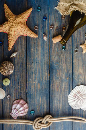 Sea and ocean gifts on a wooden background. marine things. sea products. Water Background for real man captains and sailors. pirate design. Bottle, rope, star. underwater treasures.の写真素材