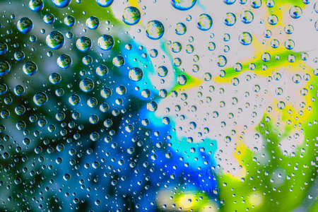 Abstract background about water or space. Multicolored stylish drops. Unusual splashes. It looks like the universe, planets and stars.の写真素材