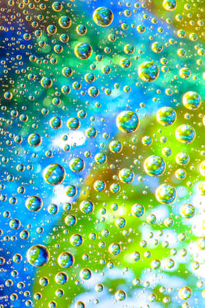 Abstract background about water or space. Multicolored stylish drops. Unusual splashes. It looks like the universe, planets and stars.の写真素材