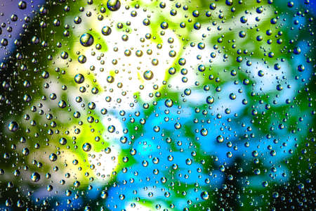 Abstract background about water or space. Multicolored stylish drops. Unusual splashes. It looks like the universe, planets and stars.の写真素材