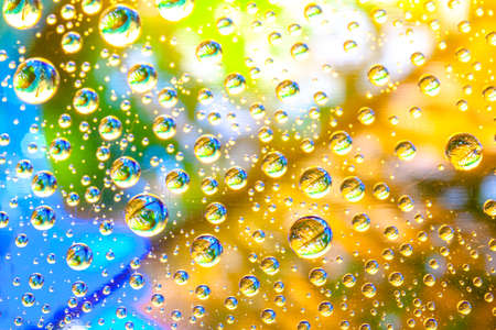 Abstract background about water or space. Multicolored stylish drops. Unusual splashes. It looks like the universe, planets and stars.の写真素材