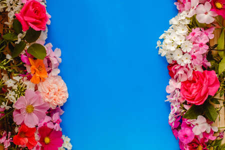 Floral summer background. Frame from spring flowers on a wooden background. Mother's day, easter or...