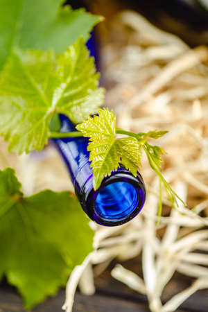 Wine bottle on a wooden background. Winemaking, sommelier.の写真素材