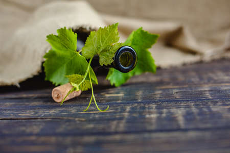 Wine bottle on a wooden background. Winemaking, sommelier.の写真素材