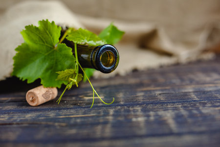 Wine bottle on a wooden background. Winemaking, sommelier.の写真素材