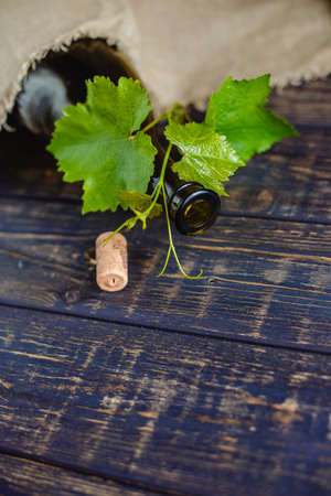 Wine bottle on a wooden background. Winemaking, sommelier.の写真素材