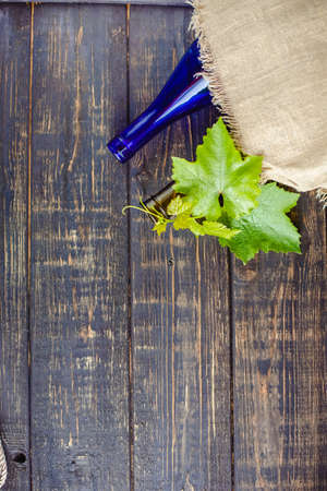 Wine bottle on a wooden background. Winemaking, sommelier.の写真素材