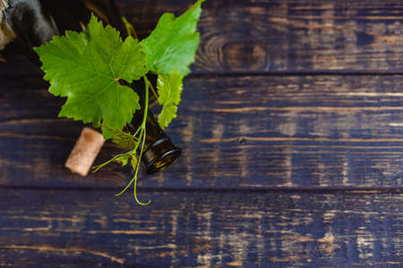 Wine bottle on a wooden background. Winemaking, sommelier.