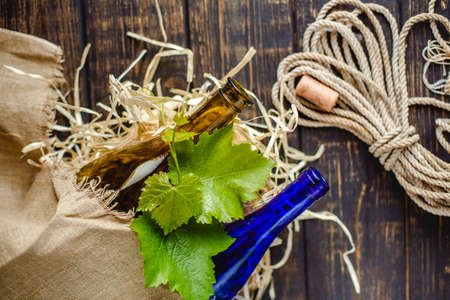 Wine bottle on a wooden background. Winemaking, sommelier.の写真素材