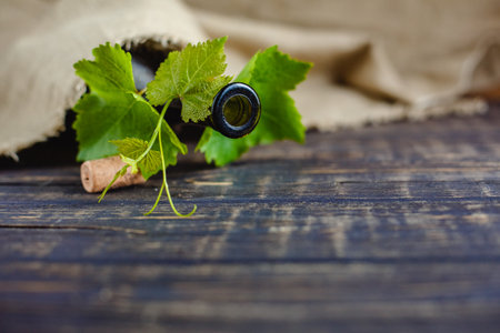 Wine bottle on a wooden background. Winemaking, sommelier.の写真素材