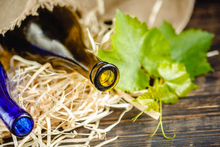 Wine bottle on a wooden background. Winemaking, sommelier.の写真素材