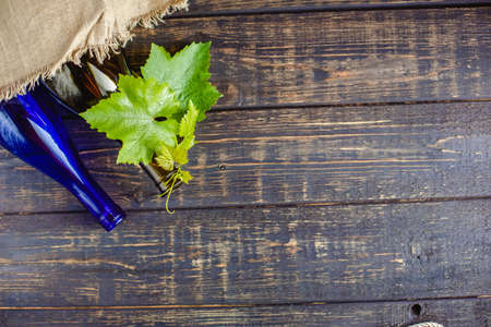 Wine bottle on a wooden background. Winemaking, sommelier.の写真素材