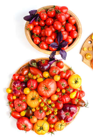 Different tomatoes on white. Vegetables of different varietiesの写真素材