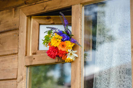 A multi-colored bouquet of wildflowers. Chamomile, cornflowers, calendula, poppy seeds. Flowers are like a rainbow. Bright summer bouquet. spring flowering.の写真素材