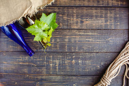 Wine bottle on a wooden background. Winemaking, sommelier.の写真素材