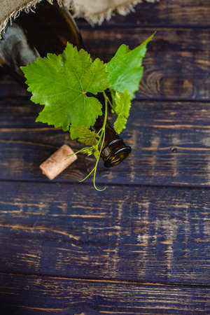 Wine bottle on a wooden background. Winemaking, sommelier.の写真素材