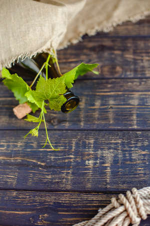 Wine bottle on a wooden background. Winemaking, sommelier.の写真素材