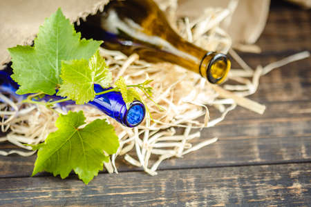 Wine bottle on a wooden background. Winemaking, sommelier.の写真素材