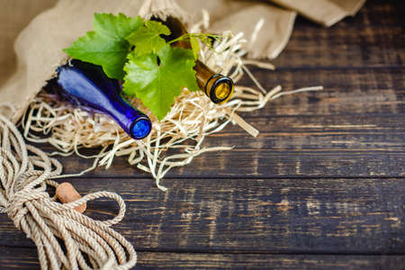 Wine bottle on a wooden background. Winemaking, sommelier.の写真素材