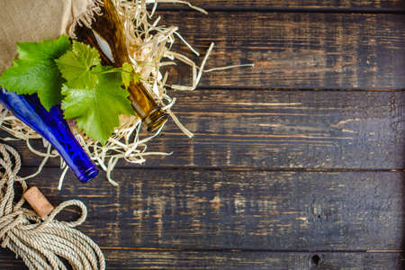 Wine bottle on a wooden background. Winemaking, sommelier.の写真素材