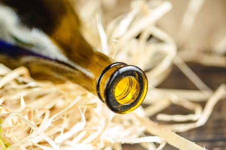 Wine bottle on a wooden background. Winemaking, sommelier.の写真素材