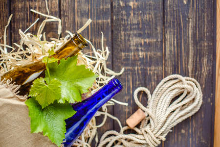 Wine bottle on a wooden background. Winemaking, sommelier.の写真素材