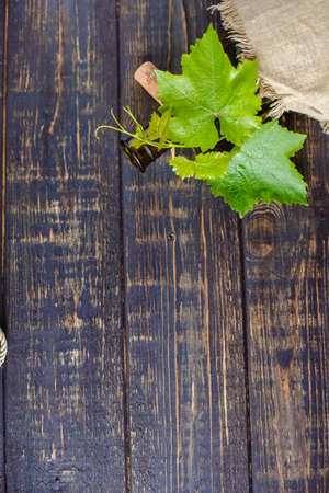 Wine bottle on a wooden background. Winemaking, sommelier.の写真素材