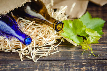 Wine bottle on a wooden background. Winemaking, sommelier.の写真素材
