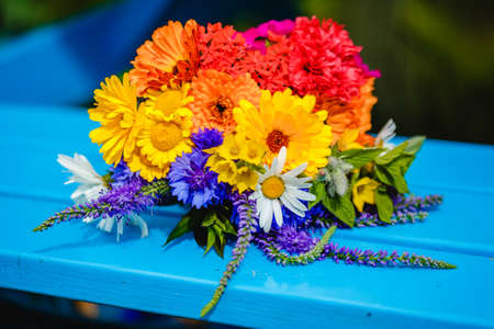 A multi-colored bouquet of wildflowers. Chamomile, cornflowers, calendula, poppy seeds. Flowers are like a rainbow. Bright summer bouquet. spring flowering.の写真素材