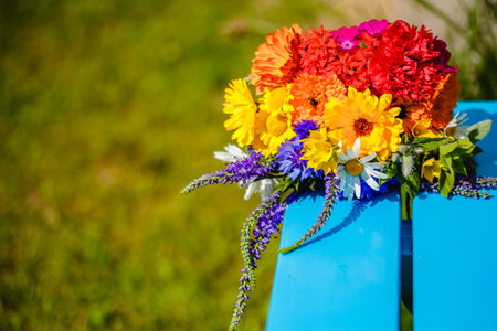 A multi-colored bouquet of wildflowers. Chamomile, cornflowers, calendula, poppy seeds. Flowers are like a rainbow. Bright summer bouquet. spring flowering.の写真素材