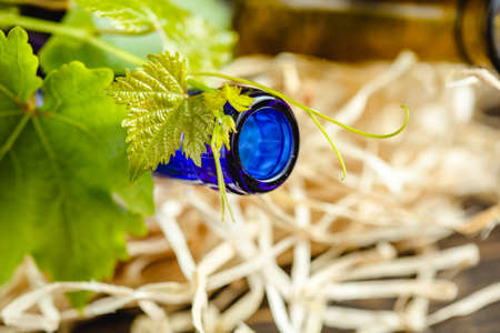 Wine bottle on a wooden background. Winemaking, sommelier.の写真素材