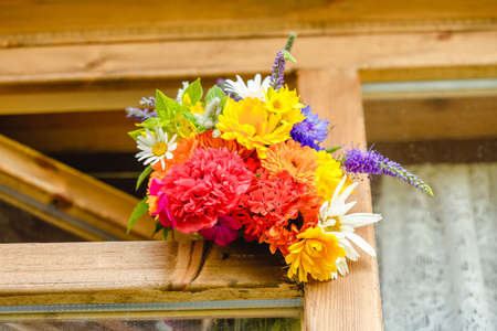 A multi-colored bouquet of wildflowers. Chamomile, cornflowers, calendula, poppy seeds. Flowers are like a rainbow. Bright summer bouquet. spring flowering.の写真素材