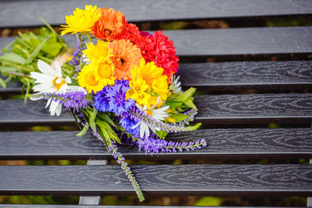 A multi-colored bouquet of wildflowers. Chamomile, cornflowers, calendula, poppy seeds. Flowers are like a rainbow. Bright summer bouquet. spring flowering.の写真素材