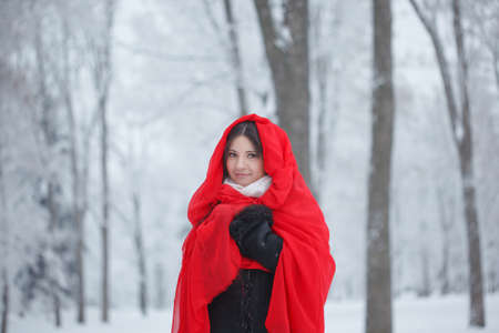 Beautiful girl on the street in winter. Woman outdoors against the backdrop of a magical winter...