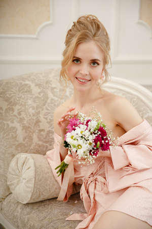 Bride with wedding flowers bouquet. Woman in wedding dress. Young fashion model with perfect skin, make up and Beautiful Hairstyle. happy day. Marriage.の写真素材